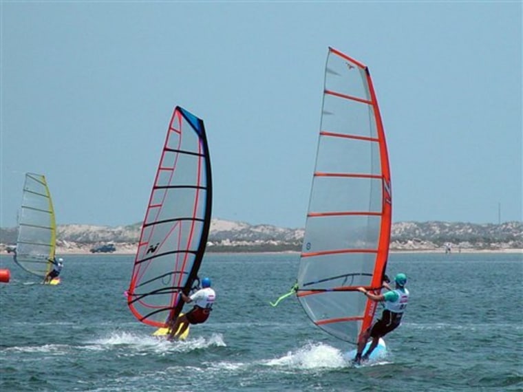 This 2008 photo courtesy of the South Padre Island Convention and Visitors Bureau shows windsurfers on Laguna Madre Bay off the western shore of South Padre Island, Texas. A steady airstream in spring and fall make Laguna Madre Bay a popular place for activities that rely on wind, like kiteboarding and windsurfing. 